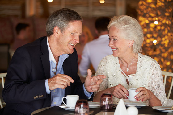 smiling couple at educational seminars enjoying a complimentary meal